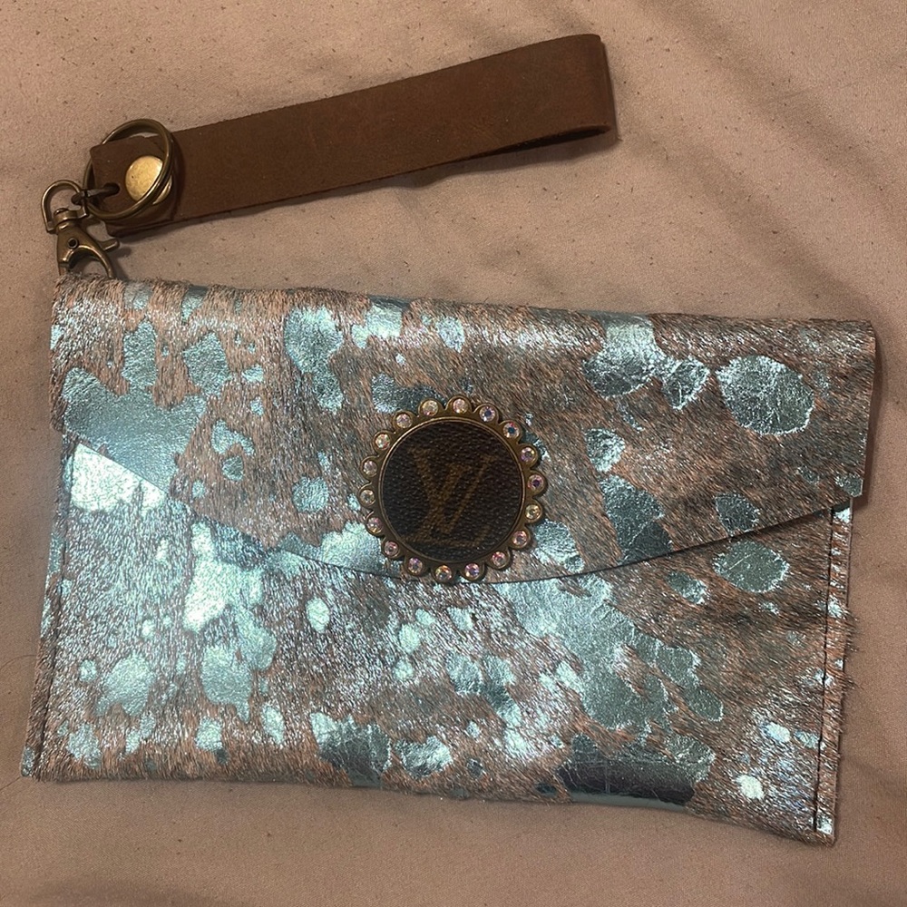 genuine leather wristlet with an authentic LV pendant surrounded by crystals